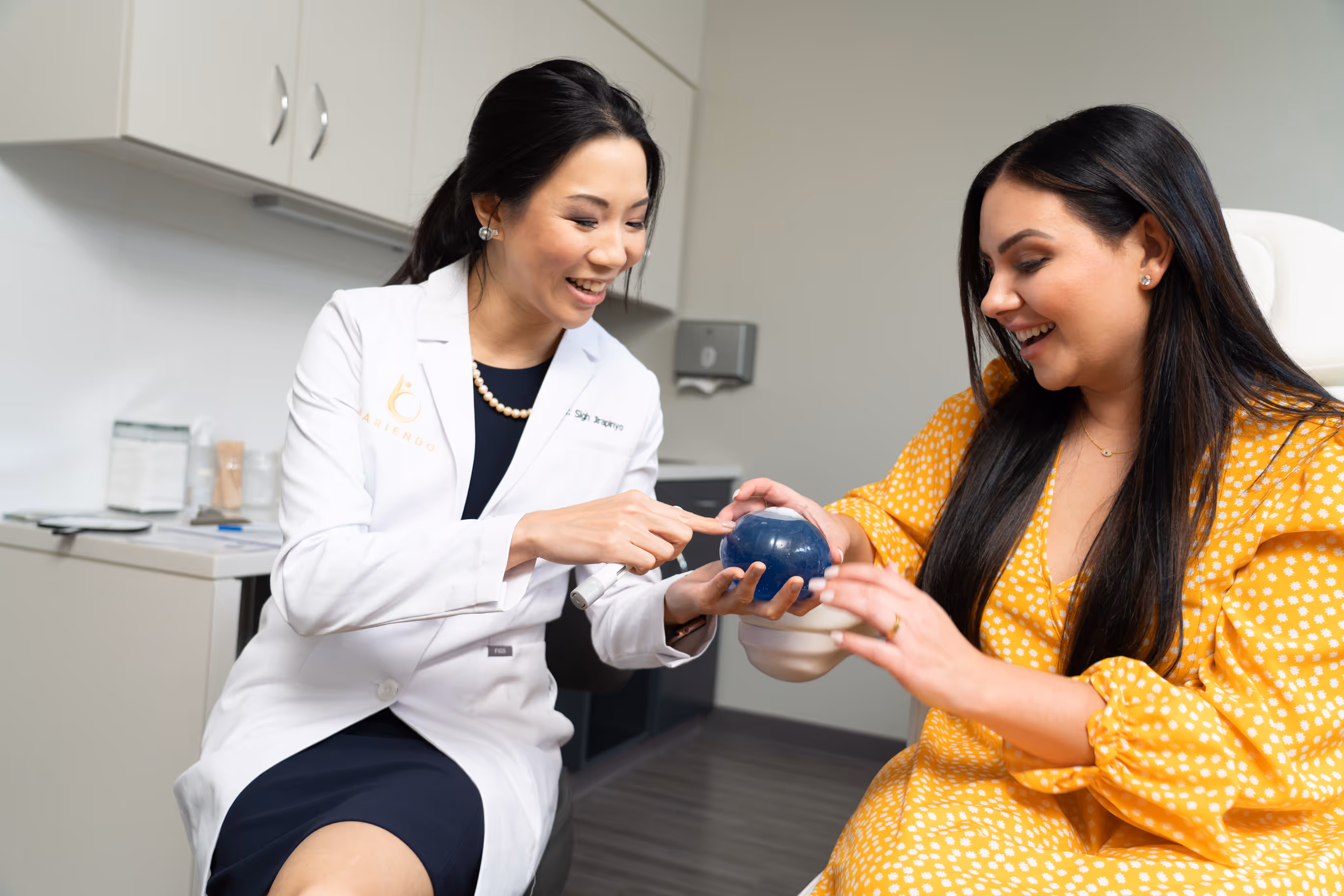 Doctor showing gastric balloon to patient