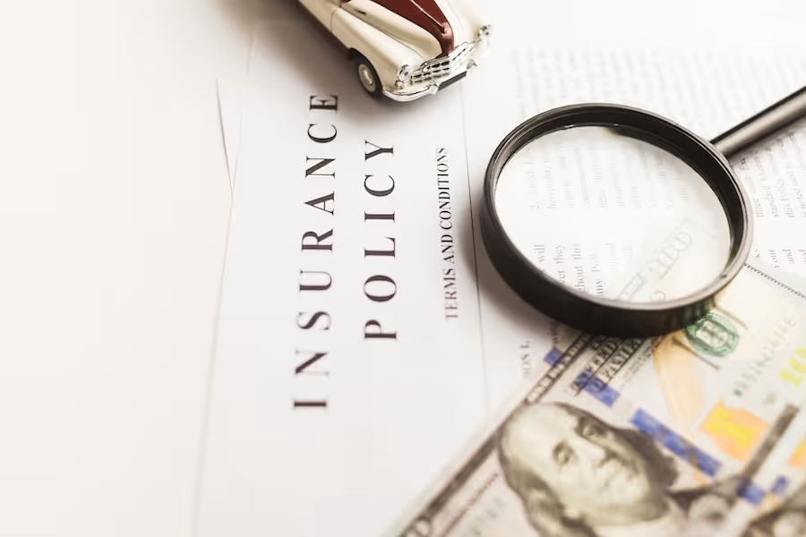 Magnifying glass on an insurance policy document
