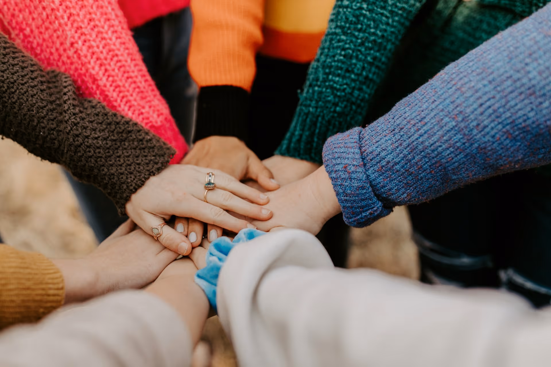girl friends hands piled together